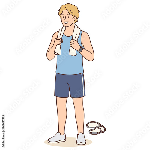 Man wearing workout clothes holds towel after exercising with jump rope