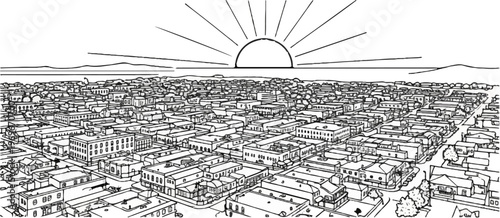 Sunrise over a dense town with varied buildings, mountains, and horizon
