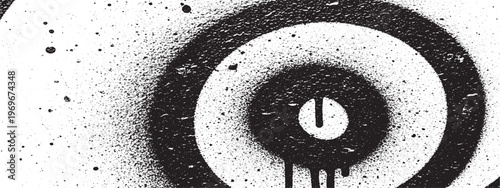 Black target symbol with spray paint splatter and drips