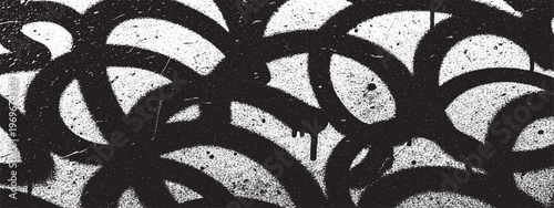 Graffiti style scribbles and loops on textured background with street art with black and white spray paint abstract background texture modern art urban