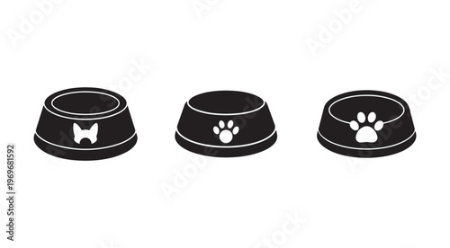 Three black dog food bowls with white dog paw and head designs on white background  pet feeding concept