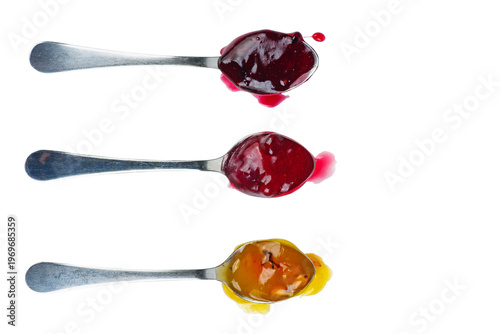 Three colored jam on a spoon isolated on a white background