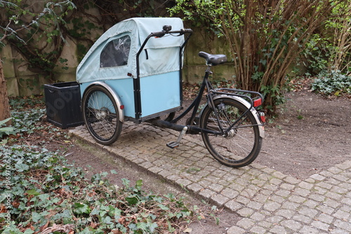 Three‑wheeled bicycle with a front carrier designed for transporting a child or pet. Practical family bike for safe and comfortable outdoor rides,showcasing modern mobility and active lifestyle,berlin