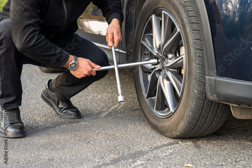 Changing a car tire, safely replacing a flat or worn tire with a new one, ensuring vehicle mobility, safety, and proper road performance.