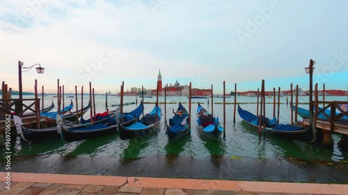 Gondola boat at grand canal venice on calm ocean wave n sea water horizon in Morning sunrise cyan blue sky n white cloud or cloudy cloudscape, Italy Europe travel destination, holiday vacation concept