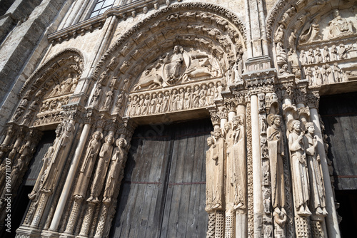 Cathedral of Chartres portal. Statue of Jesus Christ surrounded by Four Evangelists (represented as winged man,  lion, ox and eagle) and angels above the entrance. Chartres, France.