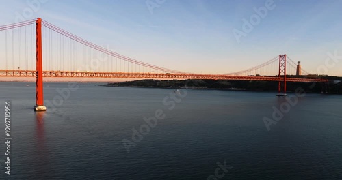 Aerial drone sunset perspective of Lisbon Portugal 25th April red suspension bridge famous iconic landmark