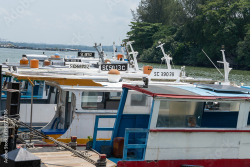 Tableau sur toile Moored boats rest near calm waters