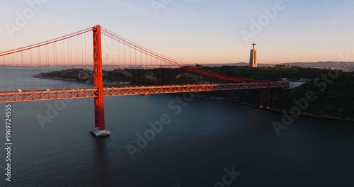 High aerial sunset scene of Lisbon Portugal 25th April red suspension bridge famous iconic landmark