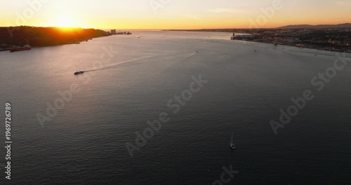 Scenic sunset panorama featuring Lisbon Portugal 25th April red suspension bridge famous iconic landmark