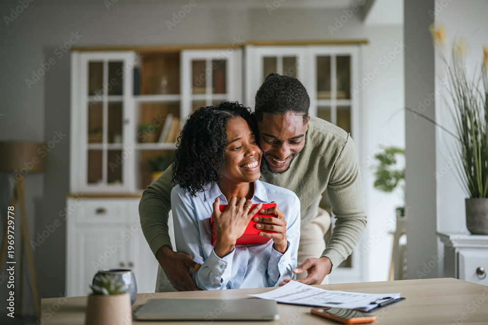 Fototapeta premium Happy couple exchanging gift showing love and appreciation