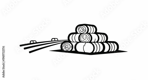 Stacked hay bales in a field with tractor tracks