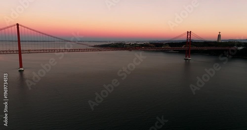 Sunset panorama along Lisbon Portugal 25th April red suspension bridge famous iconic landmark waterfront