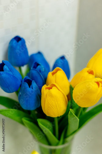 Bouquet of Blue and Yellow Tulips in Glass Vase