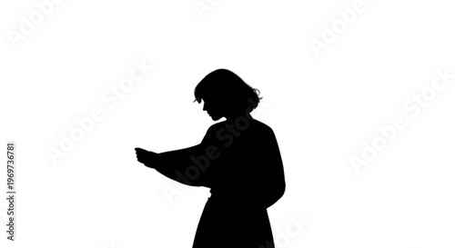 Silhouette of a person holding something in their hand
