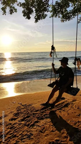 Man Sitting on a Wooden Swing at the Beach During Golden Sunset