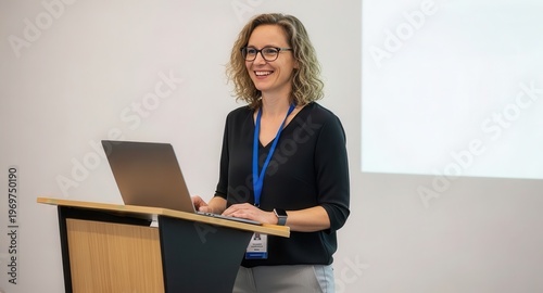 Professional Woman Presenting with Laptop at Conference Podium in Bright Modern Setting