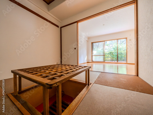 Japanese tatami room connected to bright living space with sunken hearth area