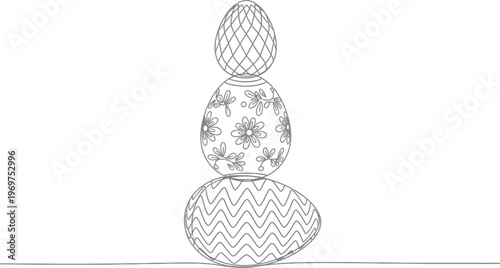 Three decorative Easter eggs stacked vertically with unique patterns
