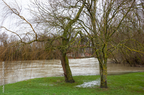 Marne river flood in Champagne, France. Abandoned house near sluice. Seasonal high water background. Economic damage concept.