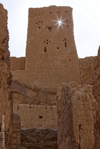Sunstar cast through a loophole in the adobe brick, rammed earth (pisé) and mud ruins of a former French Foreign Legion fort. Ksar Guedim-Morocco-178
