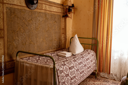 Vintage bedroom interior from the 1960s with a metal frame bed.