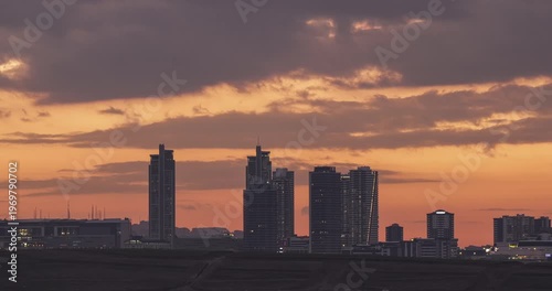 Sunset footage between the city and buildings. Dance of clouds above the buildings. Cloud movements captured with time lapse technique.