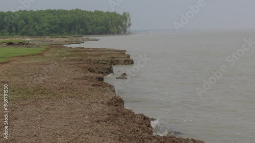 A view of the riverbank in the erosion-affected area of Char Hassan area of Bhola district. Water is rushing along the riverbank in the river erosion area. 