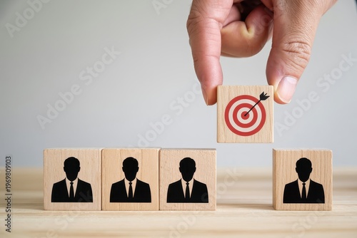Hand Placing Target Block Above Business Team Blocks For Leadership And Goal Concepts