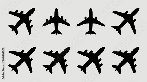Eight black silhouettes of passenger airplanes arranged in two rows on a light grey background, depicting various aircraft designs from an aerial view.
