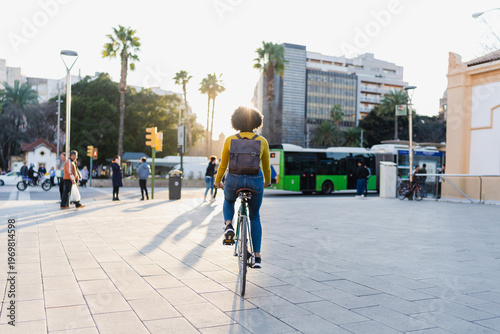 Woman riding city bicycle enjoying urban lifestyle at sunset