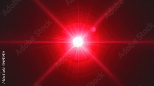 A bright red light shines in the dark with a lens flare effect
