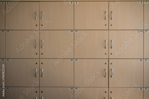 Front view of storage cabinets. Safe boxes. Archive cabinets with numbers. Symmetrical shot of  storage lockers featuring numbers and key locks.