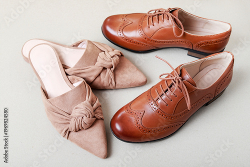 Elegant beige velvet pumps for women and brown leather Oxford shoes, luxurious and precision-crafted. Footwear for an affluent upper-class couple.