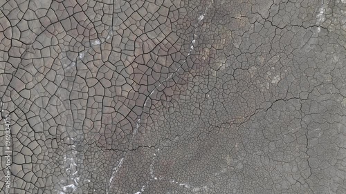 Aerial view of the intricate patterns of cracked dry earth and mineral deposits in the mining landscape of Minas de Riotinto, Andalusia, Spain.