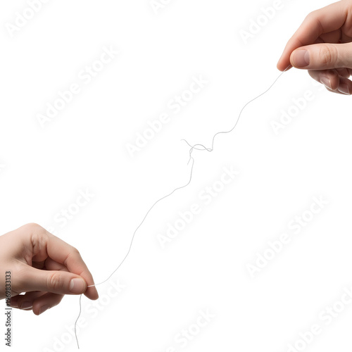 Hands holding a thin thread focused on the main subject isolated on white background.