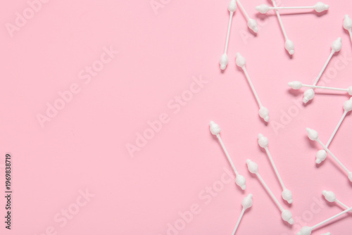 Cotton buds on pink background
