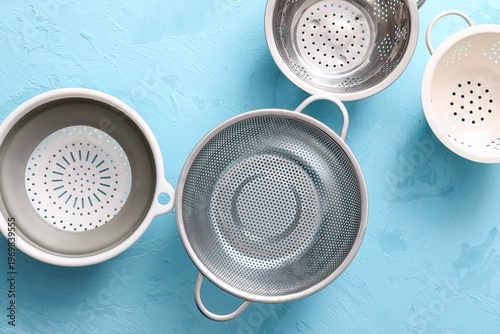 Different colanders on blue...