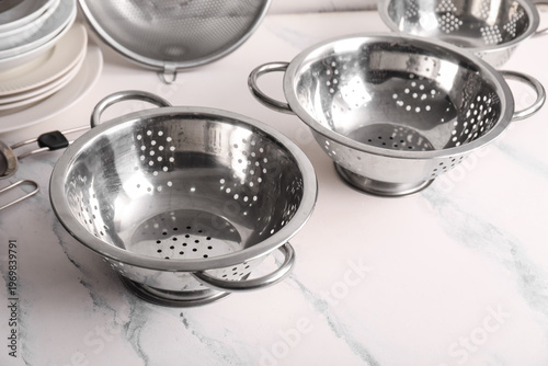 Different colanders with pl...