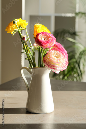 Vase with different ranuncu...