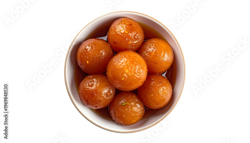 Overhead shot of a white bowl filled with syrupy, golden-brown fried dough balls
