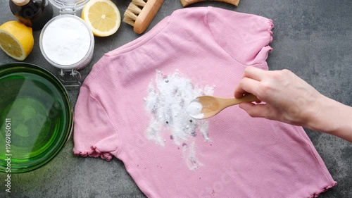 Apply baking soda to remove wine or juice stains from pink clothes in the kitchen. Natural laundry stain removers. top view. 
