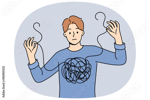 Man confused in himself and in feelings, shows lump of threads in chest and needs help of psychotherapist. Guy confused and cannot independently deal with mental health, suffered due to depression.