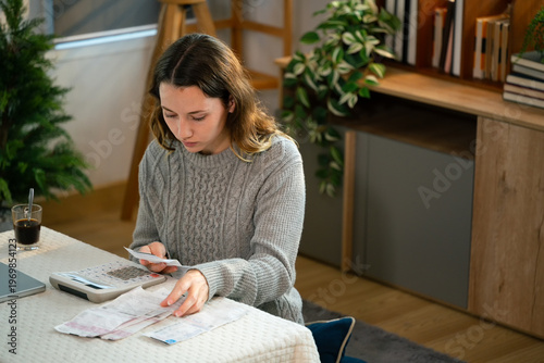 Fotografía Stressed woman calculates bills and expenses in living room