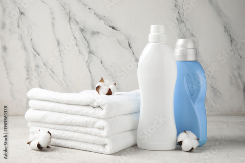 Folded clean towels, bottle...