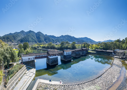 Wallpaper Mural Huizhou-Style Covered Bridge Spanning a Serene River Amidst Mountainous Countryside Landscape Torontodigital.ca