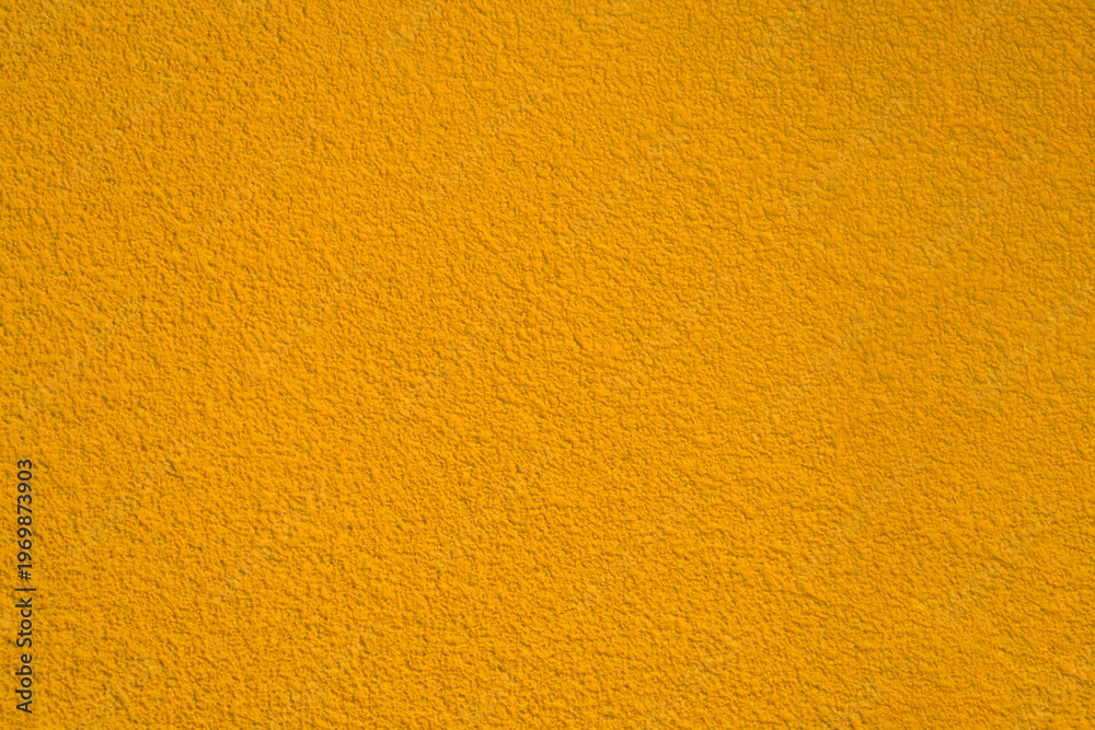 Naklejka premium modern yellow gold golden new monochrome texture with grains, warm color colour wall concrete texture pattern with grainy stained, brown stucco in plaster plastering fence floor flooring