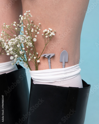 Woman with gypsophila baby breath flowers and small garden tools wearing socks creating cozy feminine gardening hobby concept with soft aesthetic mood