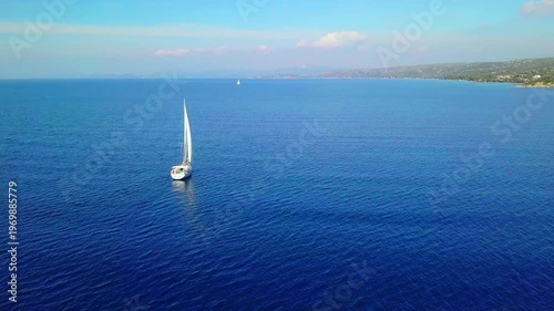A Serene Sailing Journey Across Tranquil Blue Waters Under Clear Skies in Greece