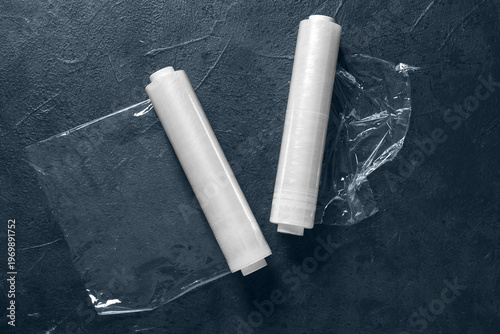 Foto Rolls of stretch wrap on dark background, top view